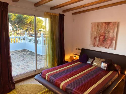 a bedroom with a bed and a large window at Villa Amaya in El Puerto de Santa María