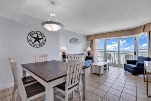 a dining room and living room with a table and chairs at Carolinian Resort 2032 in Myrtle Beach