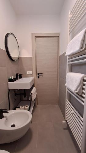 a bathroom with a sink and a toilet and a mirror at Residence San Vito in Brenzone sul Garda