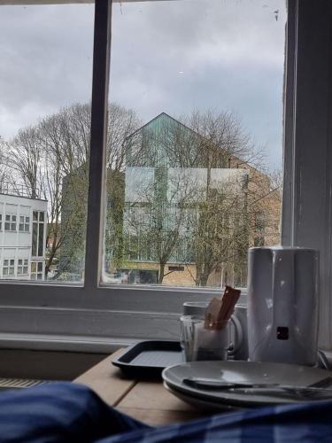 a table with a cup and a plate and a window at 2 DANESGATE in Lincoln