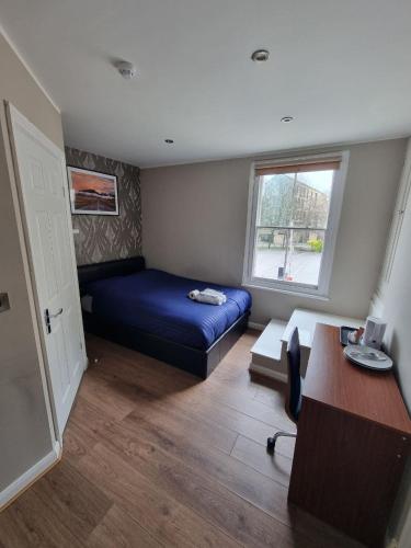 a bedroom with a bed and a desk and a window at 2 DANESGATE in Lincoln