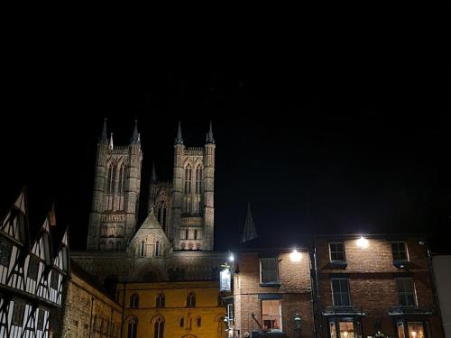 an old building with towers at night at 2 DANESGATE in Lincoln