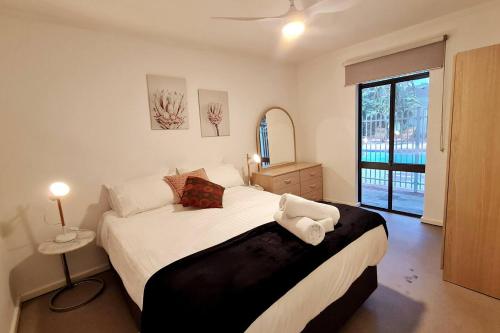 a bedroom with a large bed and a large window at West Beach Lagoon 206 - Sleeps Three! Value!!! in Perth