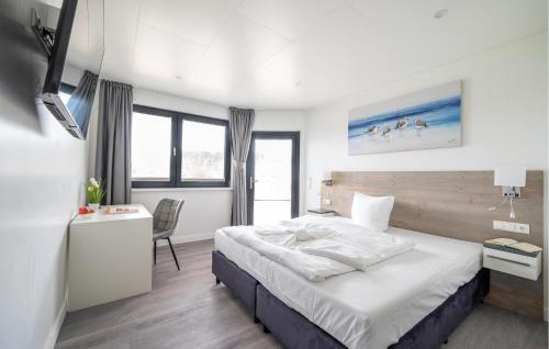 a bedroom with a bed and a desk with a chair at Apartments Waterfront in Sagard