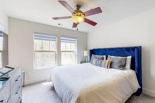 a bedroom with a bed with a ceiling fan at Shimmering Slopes in Heber City