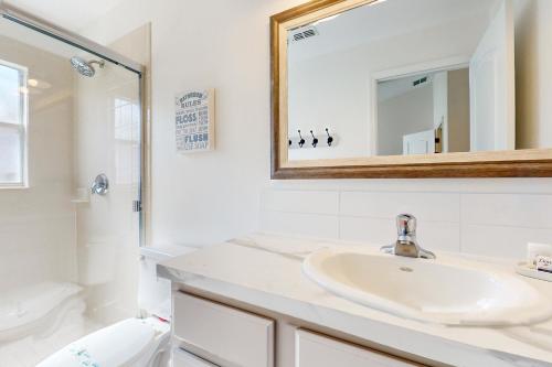 a bathroom with a sink and a toilet and a mirror at Sundrop Villa in Davenport