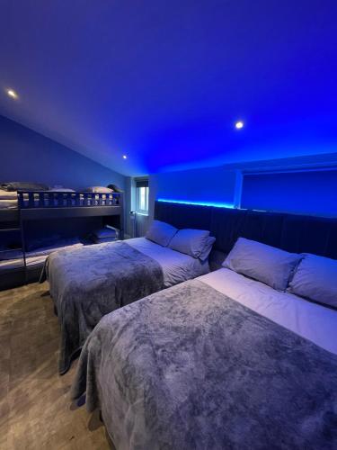 a bedroom with two beds and a blue ceiling at 19 Rodney Street Apartments in Liverpool