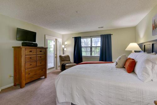 a bedroom with a bed and a dresser with a television at Beautiful Condos at Thousand Hills-Heart of Branson-Spacious and Affordable in Branson