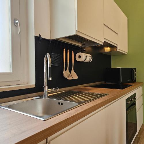 a kitchen with a sink and a counter top at Casetta Meravigliosa Paullo in Paullo