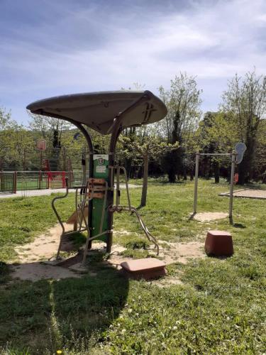 a park with a swing set in the grass at Bel appartement à 400 mètres de la rivière de l'Ardèche et de Vallon-Pont-d'Arc in Salavas