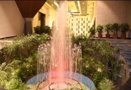 a fountain in the middle of a building at The Grand hotel and suites studio M Leo in Jaipur