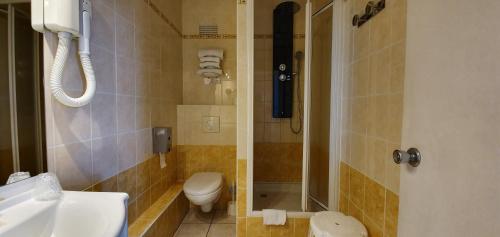 y baño con aseo, lavabo y ducha. en Hôtel Windsor Contact Hôtel en Dieppe