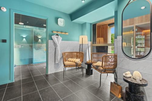 a room with two chairs and a mirror at LE RITUEL HOTEL & SPA in Honfleur