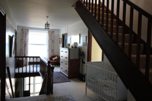 a room with a staircase and a stair case at Spacious seaside family house in Aberdaron with large garden and stunning sea views in Aberdaron