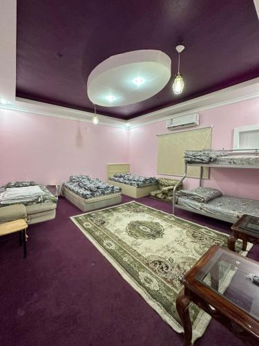 a room with four bunk beds and a table at شقة مؤثثة قريبه من المسجد النبوي in Sulţānah