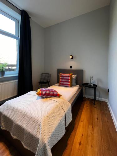a bedroom with a bed with two pillows on it at Studios am Hafen in Stralsund