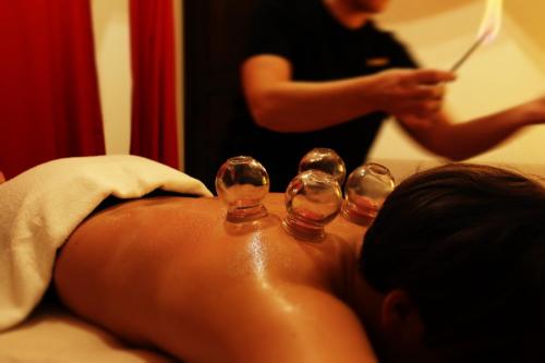 a person laying on a bed with three wine glasses at Cuore 46&48 by Travel with Gianni in Monopoli