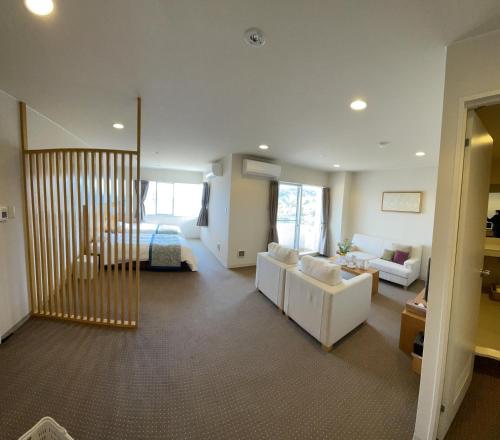 a living room with a couch and a bed at Wisterian Life Club Toba in Toba