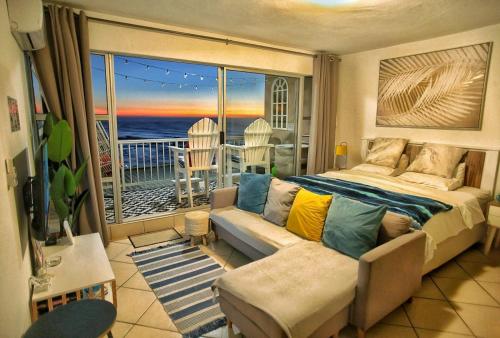 a bedroom with a bed and a view of the ocean at OCEAN WHISPER II - Power back up, Sea facing, Umdloti in Umdloti
