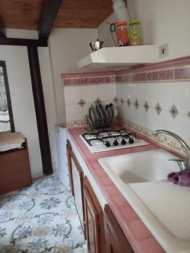 Il comprend une cuisine équipée d'une cuisinière et d'un évier. dans l'établissement Ischia forio monolocale arredato, à Ischia