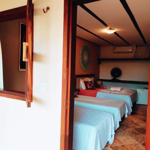 a room with two beds in a room at Pousada Tropical Brasil Jeri in Jericoacoara