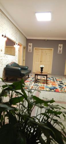 sala de estar con sofá y mesa en Ünver Hotel en Adana