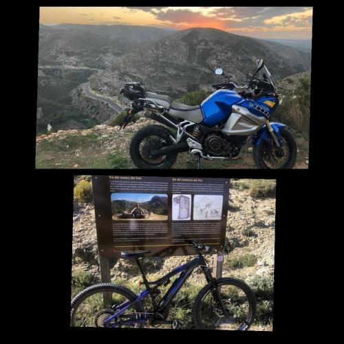 a blue motorcycle parked on a hill next to a sign at B&B Casa Josa in Ontinyent