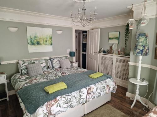 a bedroom with a bed and a chandelier at Unique seafront 2 bedroom apartment in Folkestone