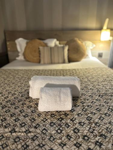 a pair of towels sitting on a bed at Alexandra in Lyon