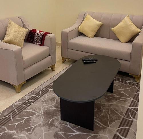 a living room with a couch and a table at شقق العاصفه4 in Khamis Mushayt