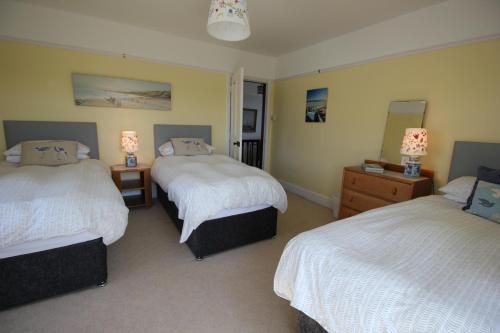 a hotel room with two beds and two lamps at Spacious seaside family house in Aberdaron with large garden and stunning sea views in Aberdaron