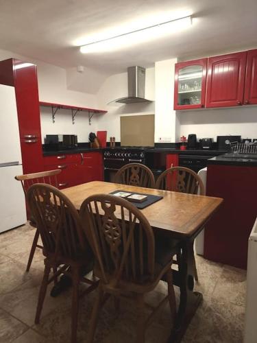 a kitchen with a wooden table and chairs at Home in Kington St Michael in Stanton Saint Quintin