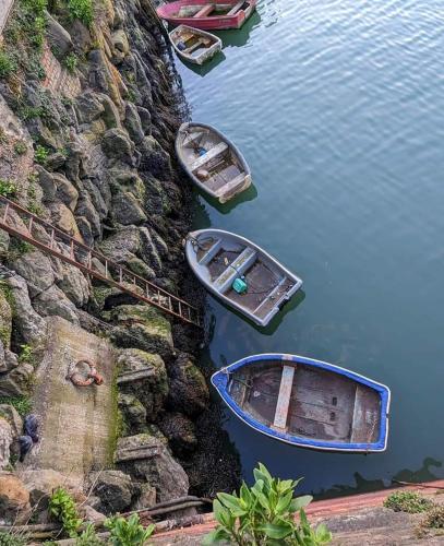 a group of boats are sitting in the water at Unique seafront 2 bedroom 2 bathroom apartment in Folkestone