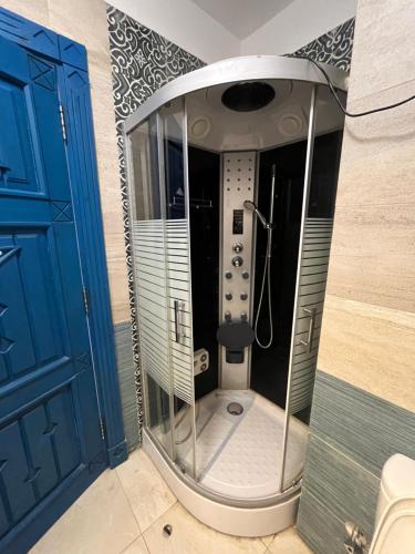 a shower in a bathroom with a blue door at Amazing 4 Bedrooms Panoramic Sea View Private Villa With Pool, Jacuzzi, Amaros Sahl Hasheesh, Hurghada in Hurghada