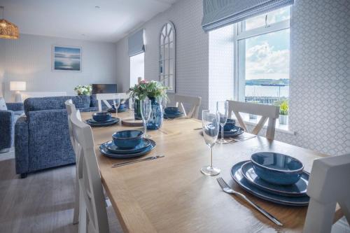 a dining room with a table with chairs and a dining room at Haven View - 2 Bedroom Apartment - Milford Haven in Milford Haven
