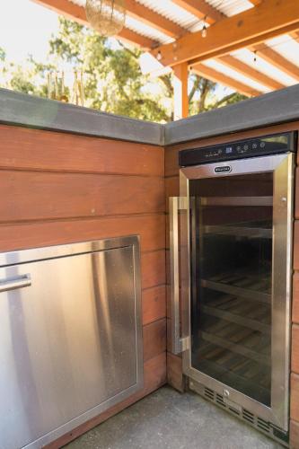 a microwave oven sitting next to a wooden wall at Serene Vineyard Chateau with Pool, Hot Tub, BBQ in Carmel Valley