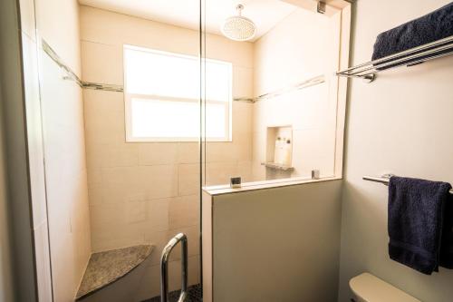 a bathroom with a shower with a glass door at Serene Vineyard Chateau with Pool, Hot Tub, BBQ in Carmel Valley