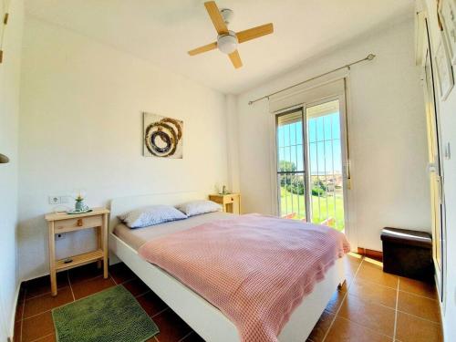 a bedroom with a bed and a ceiling fan at ALBATROS GOLF - ISLANTILLA in Islantilla