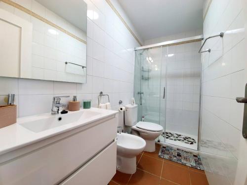 a bathroom with a toilet and a sink and a shower at ALBATROS GOLF - ISLANTILLA in Islantilla