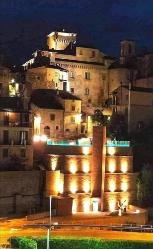 a building with lights in front of it at night at Borgo Vecchio in Carbognano