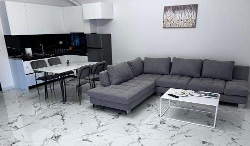 a living room with a couch and a table at Prime Luxury Apartments in Lushnjë