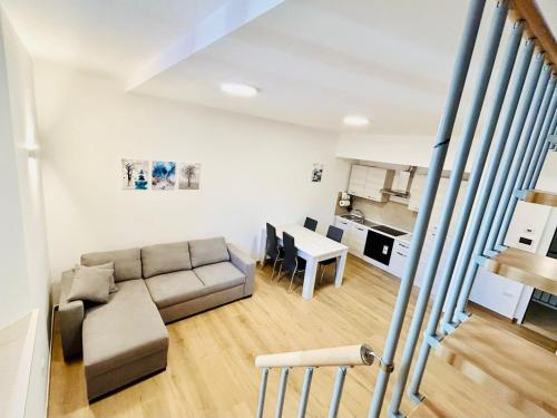 a living room with a couch and a table at SMART SUITES FORLI' in Forlì