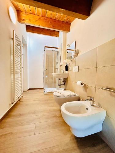 a bathroom with a toilet and a sink at SMART SUITES FORLI' in Forlì