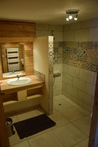 une salle de bain avec un lavabo et une douche dans l'établissement Le vieux madrier, à La Clusaz