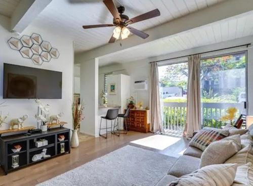 a living room with a couch and a ceiling fan at Kona Mansions in Kailua-Kona