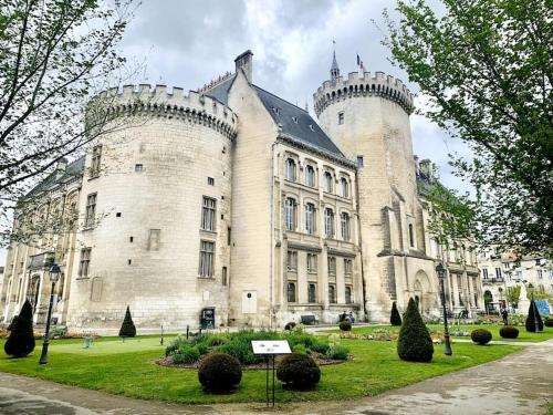 a large castle with two towers on top of it at Marie Lou à la ville in Angoulême