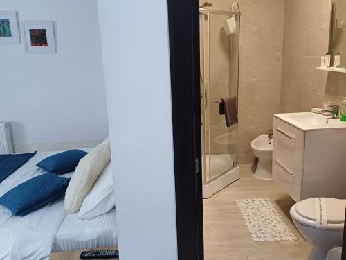 a bathroom with a bed and a shower and a toilet at Lora Studio in Mamaia Nord