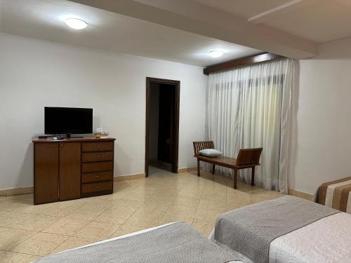 a bedroom with a bed and a television on a dresser at Terrazas Vista Verde in Asuncion