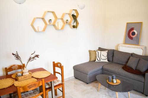 a living room with a couch and a table at Filia's Countryside House in Chania Town