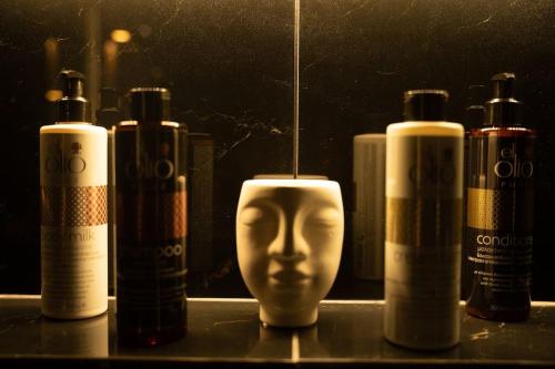 a group of three bottles of alcohol and a head candle at Cooper's Cave house with heated Jacuzzi in Megalokhori